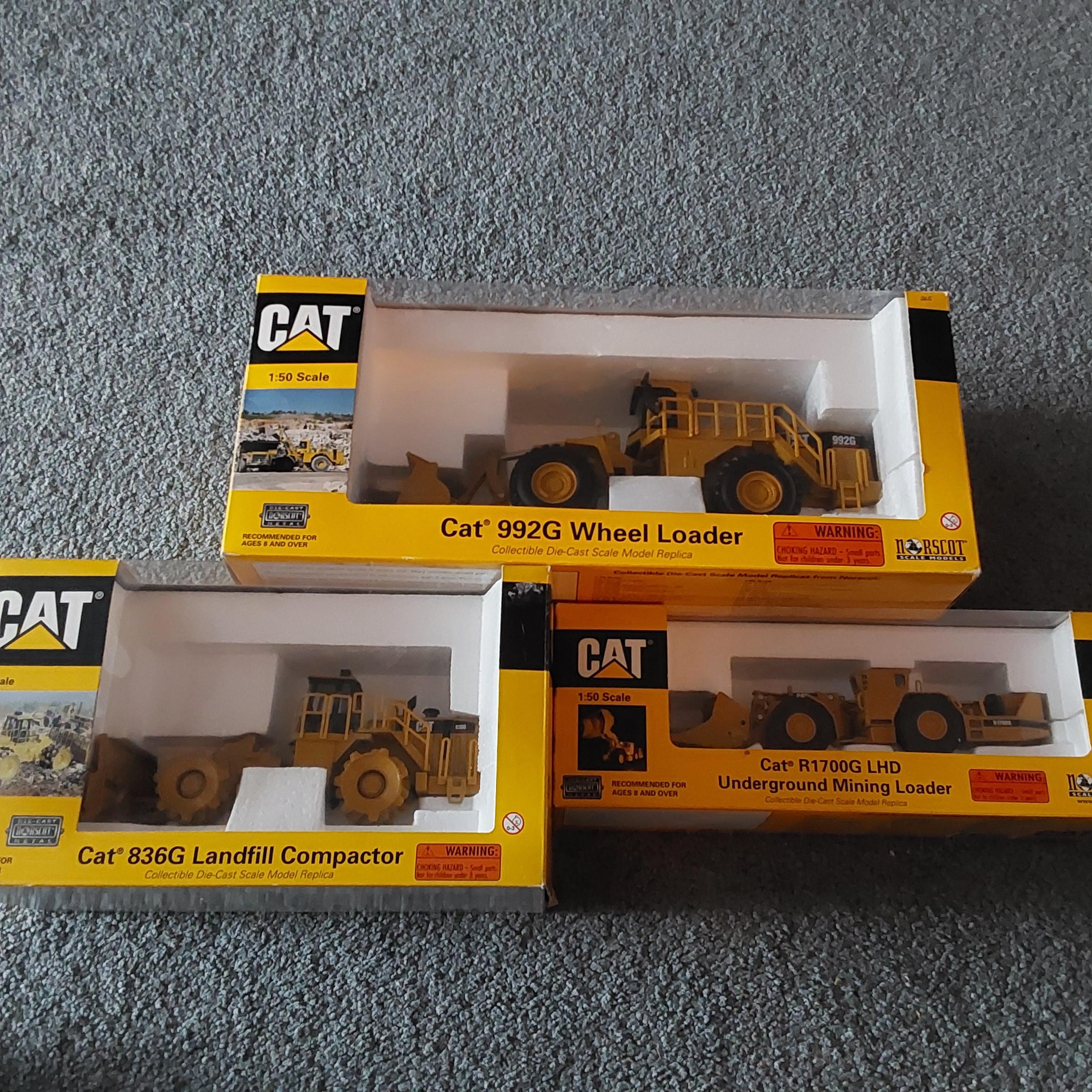 Photo of 3 Norscot CAT 1:50 scale die-cast construction models with boxes, $95 and up.