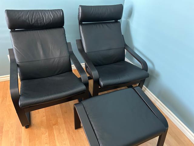 Photo of Two like new leather Poang chairs with an ottoman