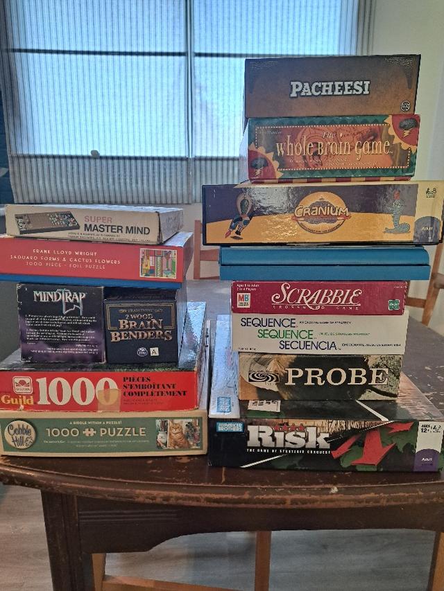 Photo of 11 board games and 3 puzzles