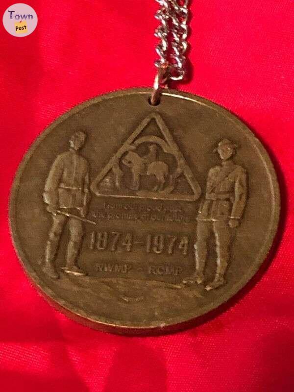 Photo of RCMP 1874 to 1974 anniversary medallion on chain necklace.