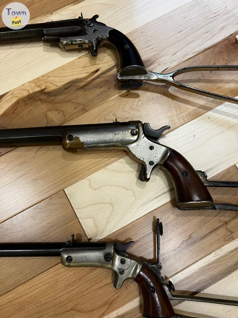 Photo of 3 antique rimfire Pistols with shoulder stocks