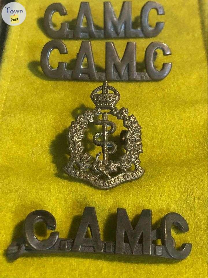 Photo of World War I Canadian Army Medical Corps shoulder titles and cap badge.