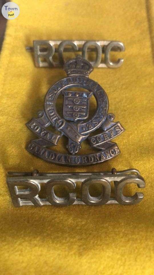 Photo of World War II Royal Canadian Ordinance Corp Cap Badge and titles.