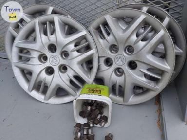 Photo of SET OF 4 HUB CAPS AND LUG NUTS 2007 OR OLDER GRAND CARAVAN - 1