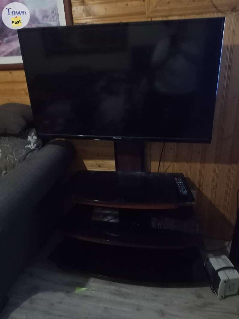 Photo of hiense tv  and glass stand