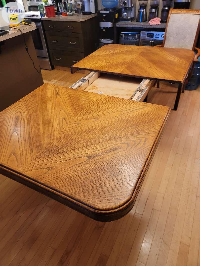 Photo of Oak table. 6 chairs and corner hutch . 