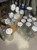 Photo of 25 x 1 GALLON RUGGED PLASTIC JARS WITH LIDS.