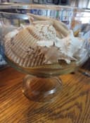 Photo of Pedestal glass bowl with sand and shells