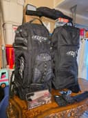 Photo of 2 Dye Navigator Paintball Gear Bags and accessories.